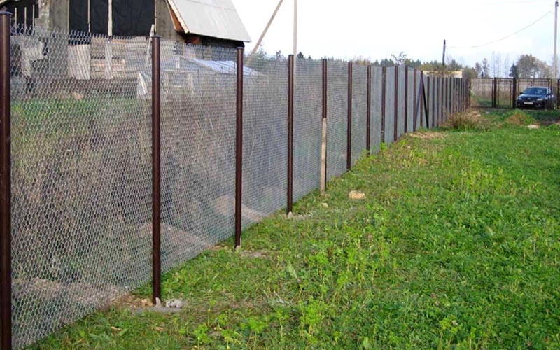Забор металлический из сетки рабицы со столбами бордового цвета